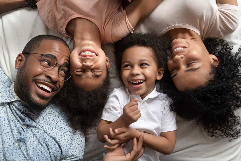 Smiling family of three lying together on the floor